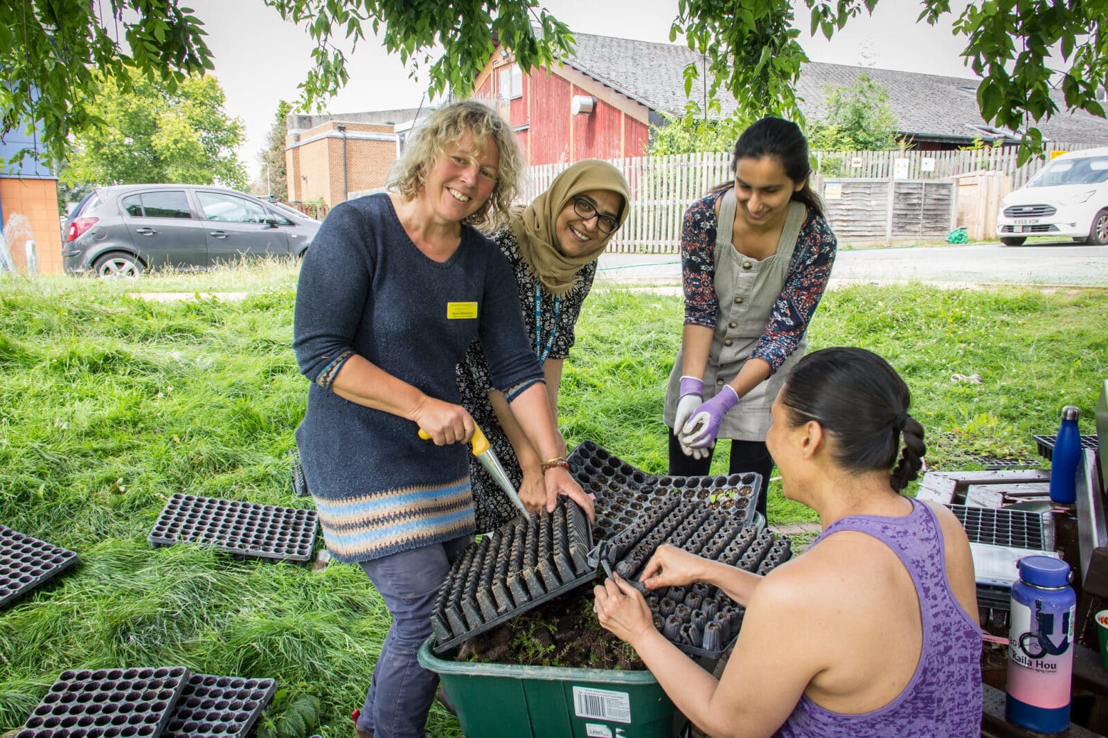 Ranger Karen MacKelvie with volunteer staff and community members plug planting a wildflower meadow at Mount Vernon Cancer Centre