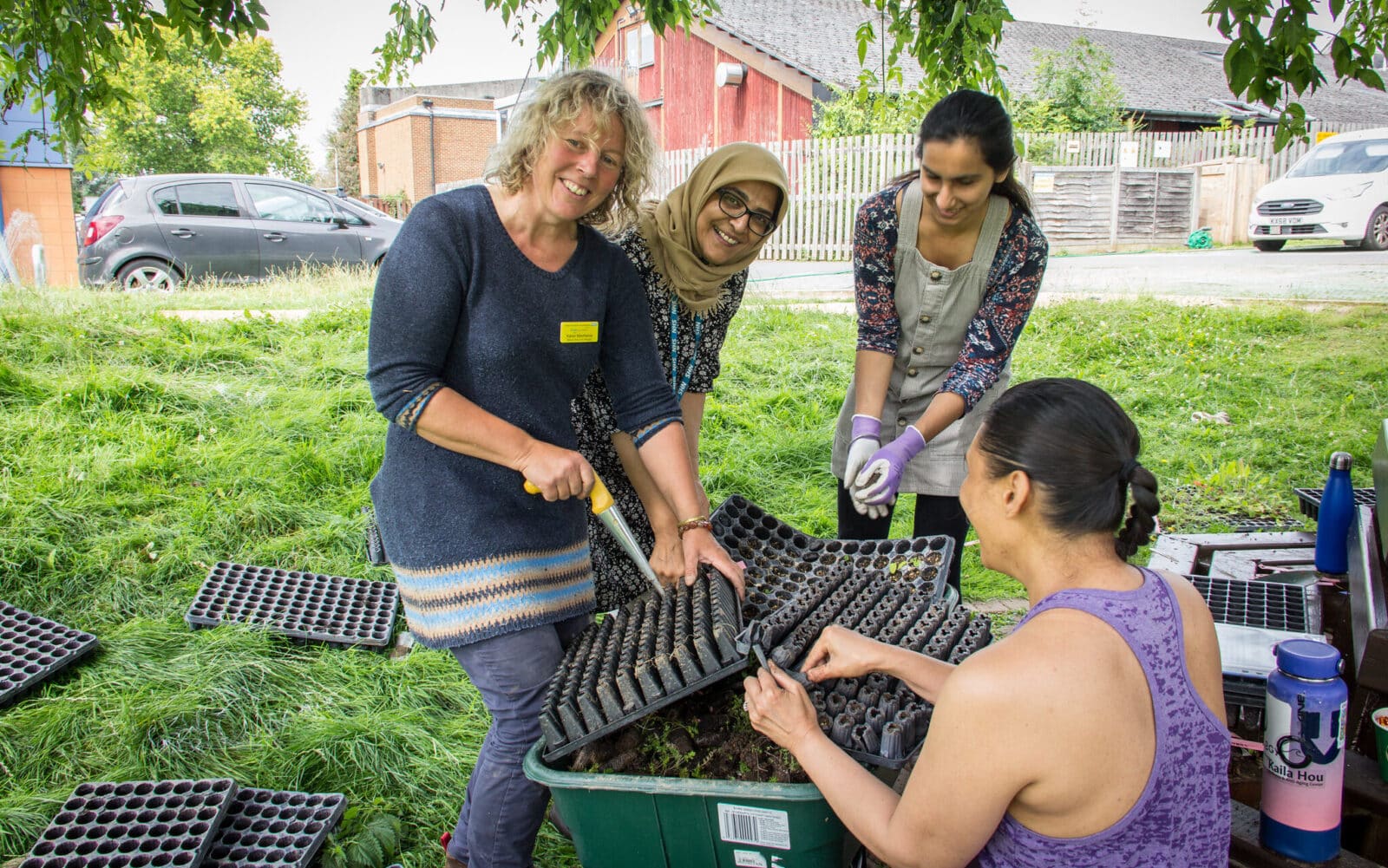 Ranger Karen MacKelvie with volunteer staff and community members plug planting a wildflower meadow at Mount Vernon Cancer Centre