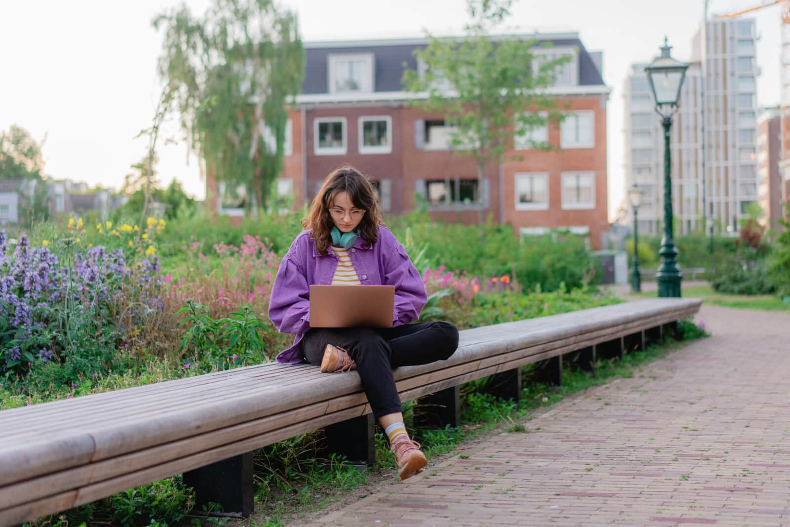 Person sat outside with laptop. Credit: Oleh_Slobodeniuk/iStock. All rights reserved.