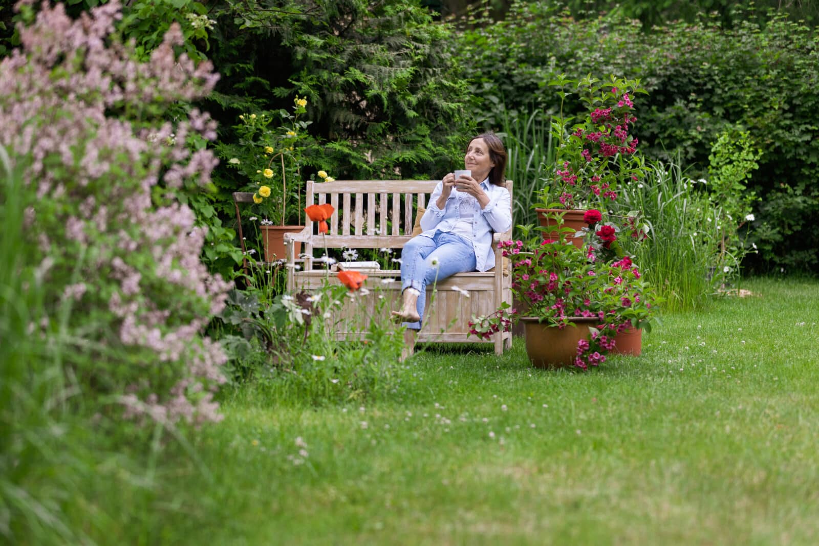 Shot of a woman relaxing at flower garden. Credit iStock