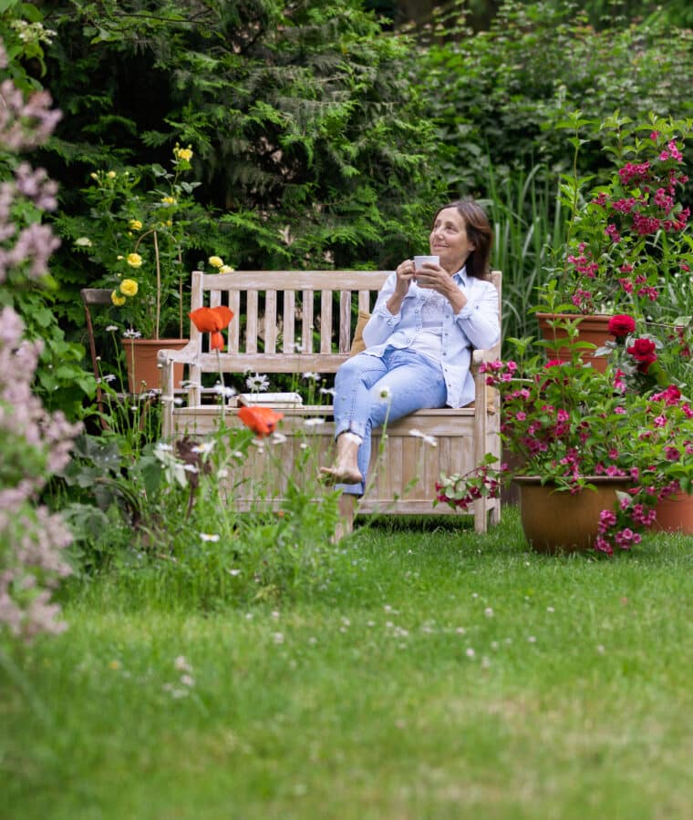 Shot of a woman relaxing at flower garden. Credit iStock